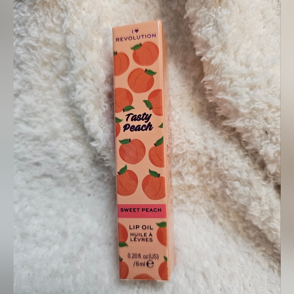 I Heart Revolution Tasty Peach Lip Oil in the shade "Sweet Peach."